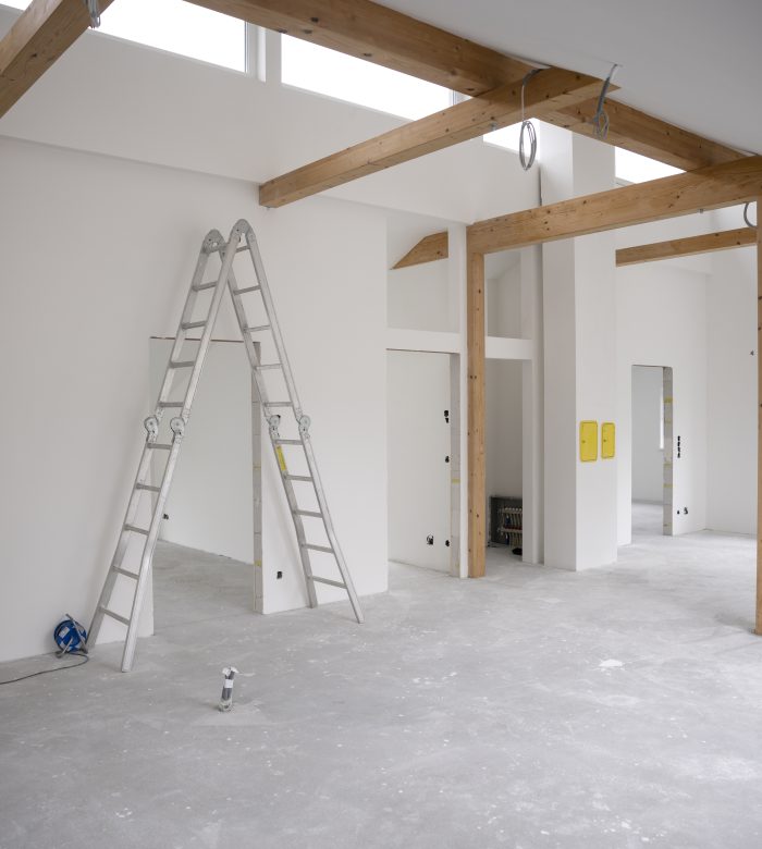 modern attic construction site freshly painted, the floor is still screed, walls are white